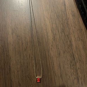 Roxanne Assoulin red letter S Charm Gold necklace.
